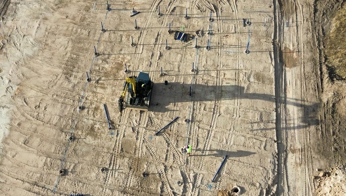 Aerial view of an engineered screw pile grid set out across a Victorian site