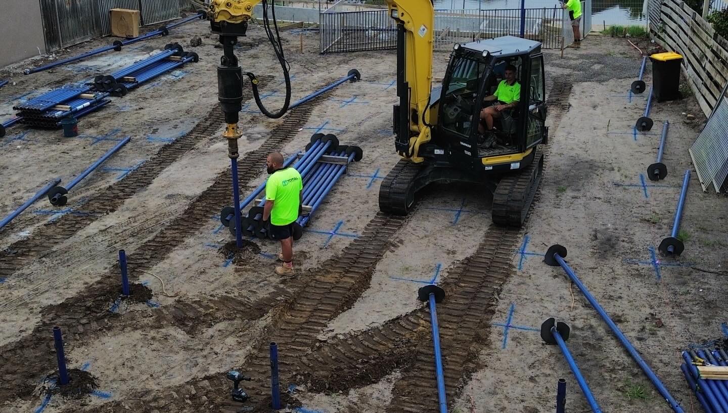 Multi-unit residential screw pile install with shoring panels and brackets
