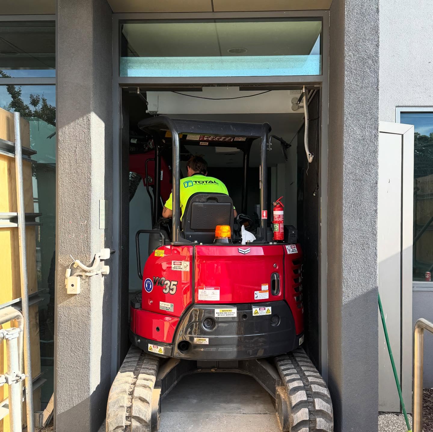 Total Piling mini excavator working through a residential doorway for tight-access underpinning